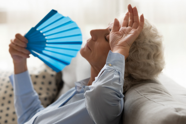 senior woman fanning herself
