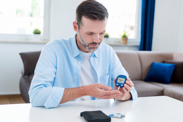 man checking blood sugar