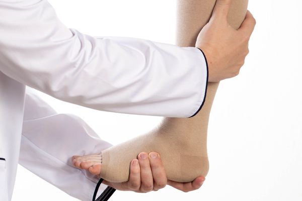 patient being fitted for compression stockings