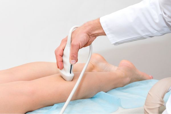 doctor performing leg ultrasound